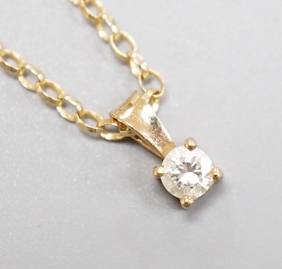 A modern 9ct gold and diamond set pendant, on a 9ct gold chain, chain, 38cm, gross weight 2.2 grams.